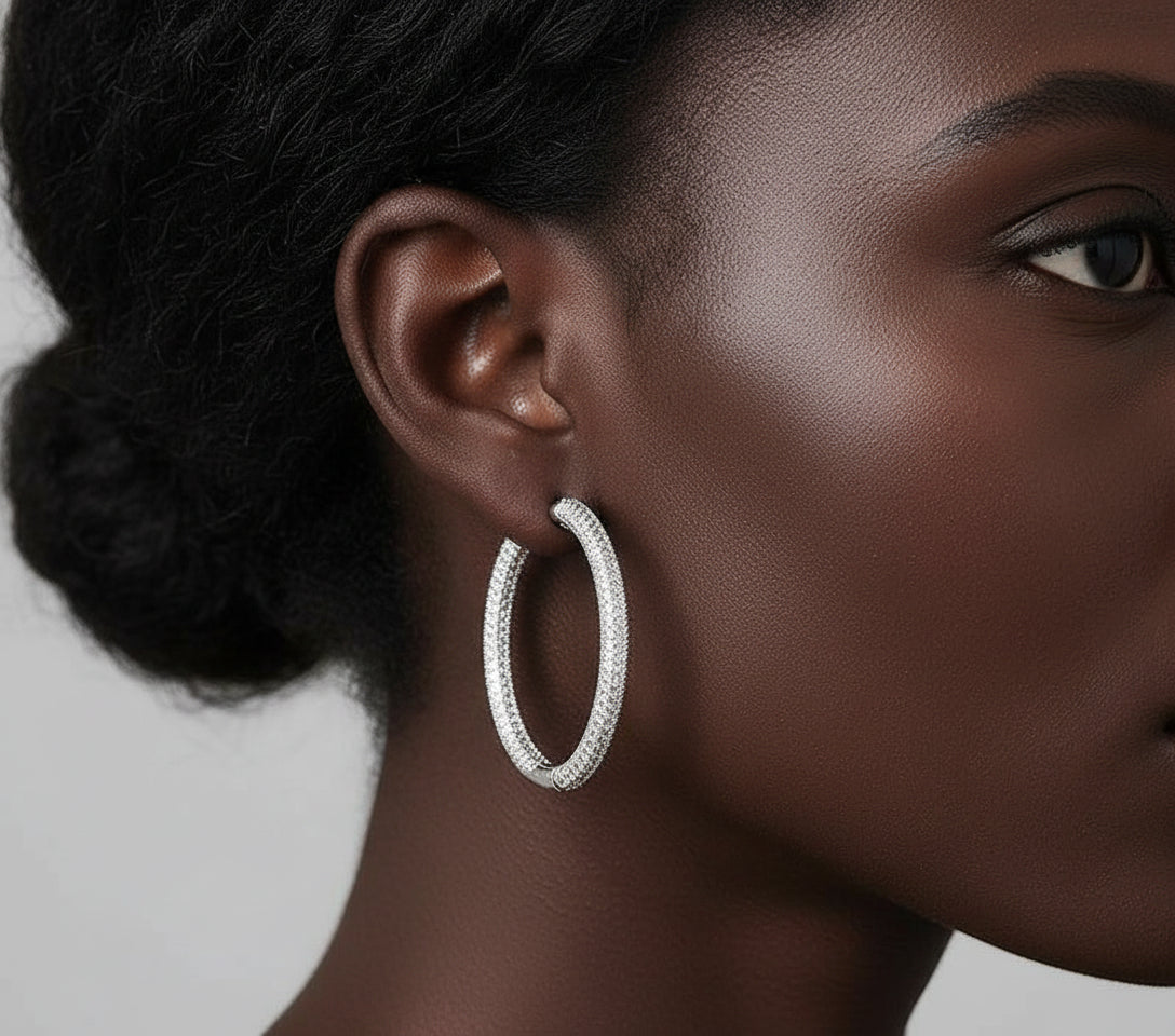 Close-up of a person wearing a silver hoop earring.